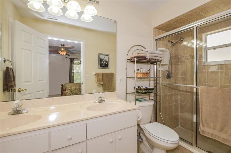 Master Bedroom w/ Dual Sinks & Tiled Shower