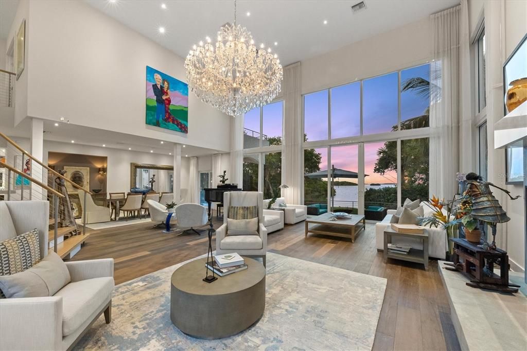 The enormous living room boasts cathedral ceilings and two-story windows