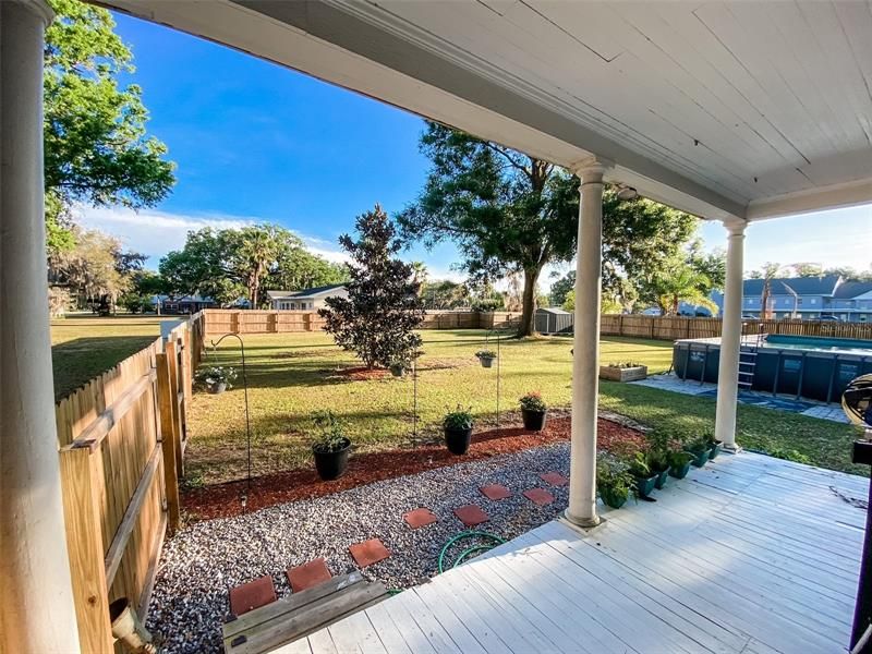 Back porch looking out towards fenced yard