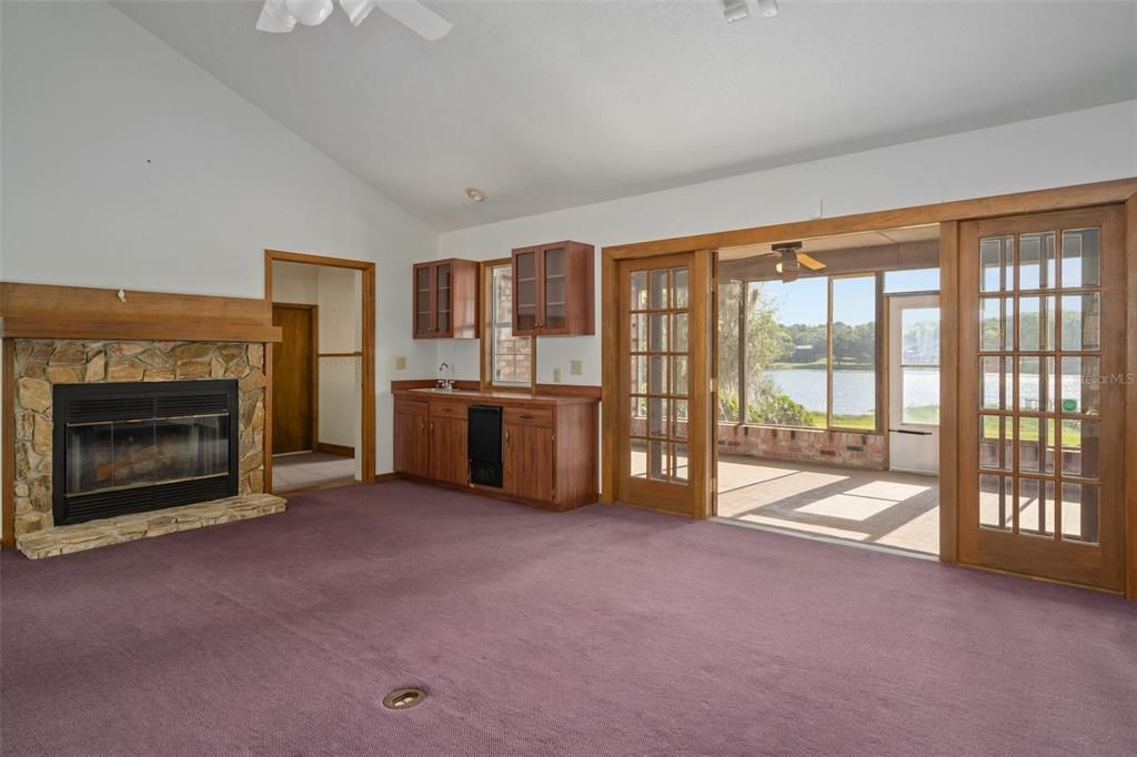 Great room fireplace and screened lanai. Wet bar to the left leads out to office or extra bedroom or mudroom