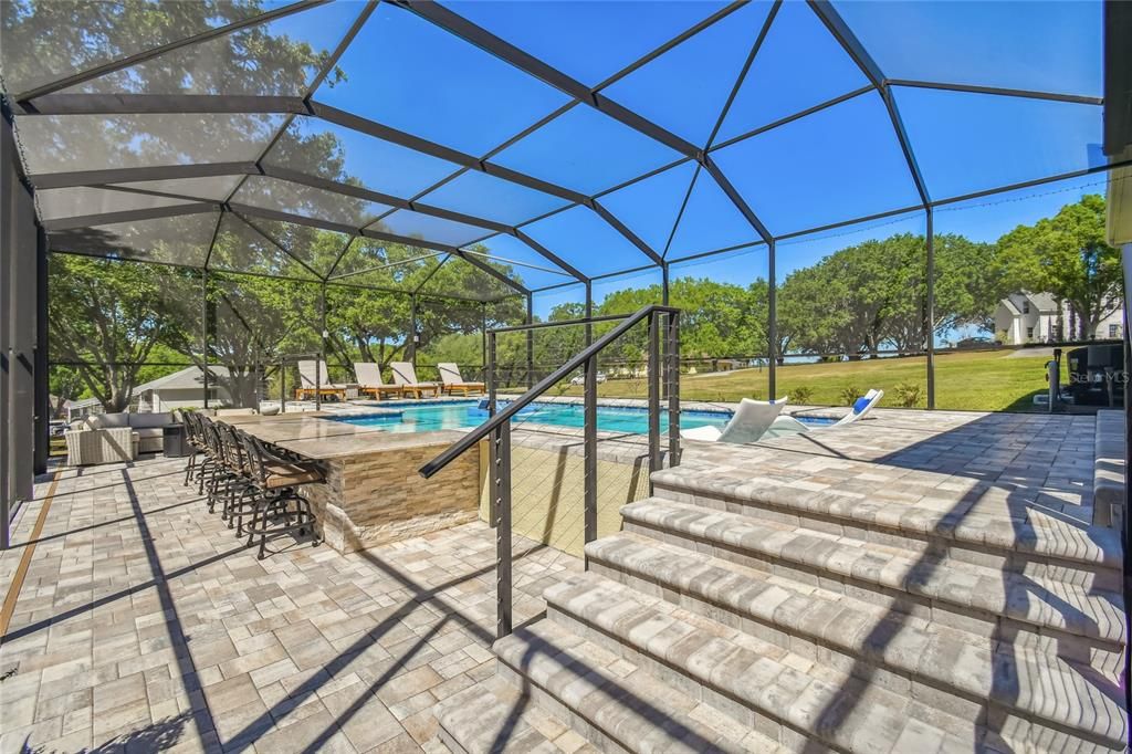 The lower level of the pool area provides plenty of space for outdoor living