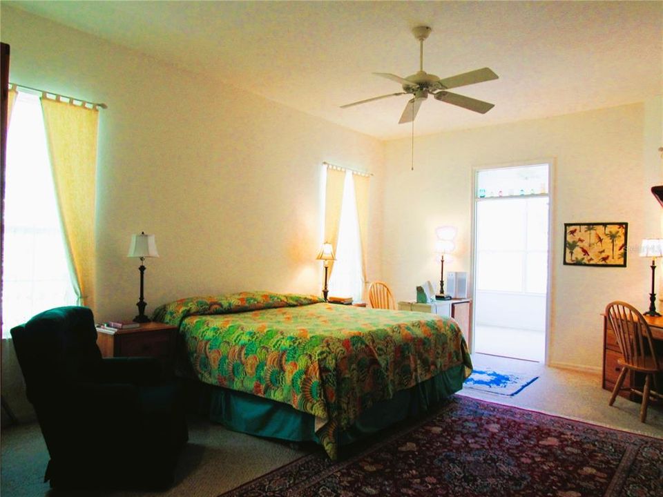 A Cheerful Warm Glowing Owner's Suite w/ Large Windows & Entrance Into Conservatory Viewing Room!