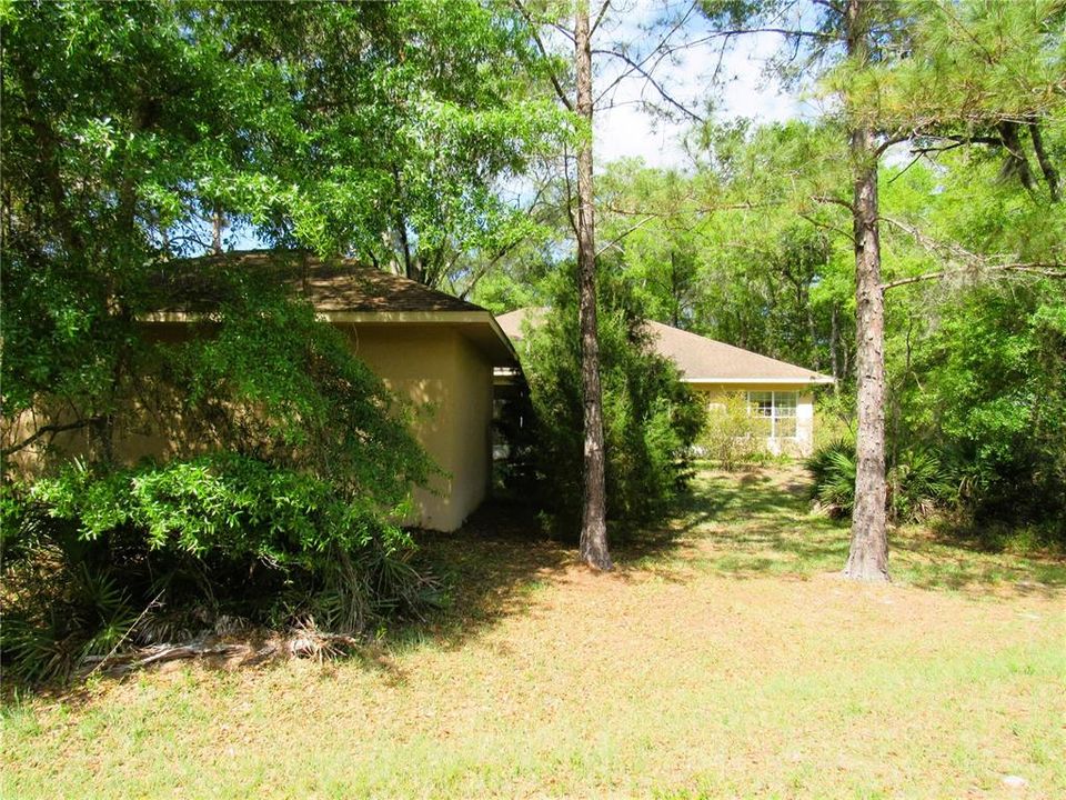 Shot From From Rear Of Property Showing Back of Home + Detached Garage. Plenty of Room For A Brand New Pool!