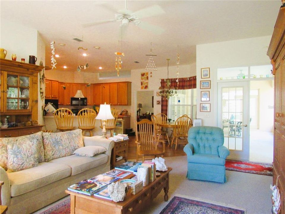 Another Image Of The Cheerful & Friendly Family Room With Double French Doors To The Voluminous Screen Enclosed Lanai.