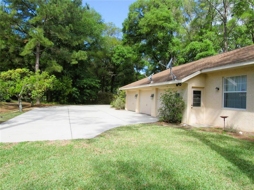 Attached 3-Car Garage W/ Huge Turn Pad Facing Front Yard With Long Winding Driveway.