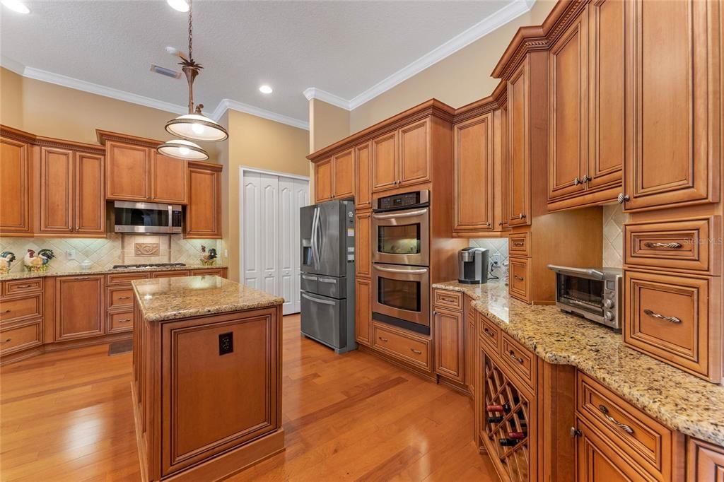 Kitchen has tons of storage, cooking island, built in wine rack and convection ovens.