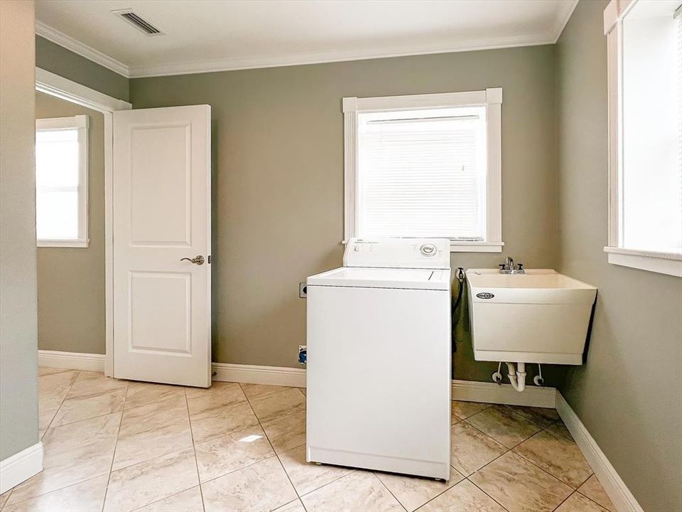 Laundry Room, located between the Primary Bedroom and Garage
