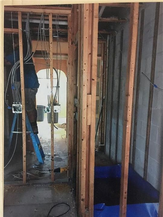 Standing in the kitchen. Here we see what will be the refrigerator space (left) and primary shower stall (right).