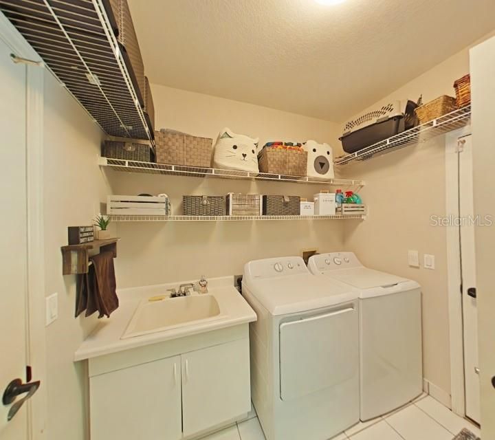 Laundry room with laundry tub, extra storage shelving added