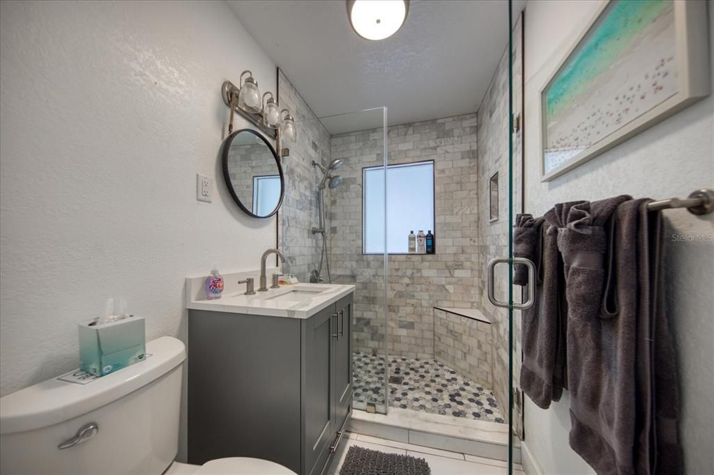 Bath area with walk in shower in first level unit Beautifully remodeled!