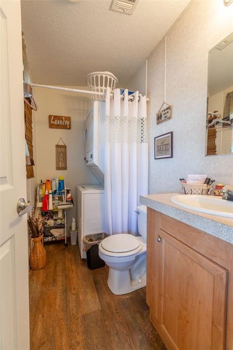 This is the inside utility and half bath located close to bedroom #3.  Stackable washer and dryer will remain with the home.