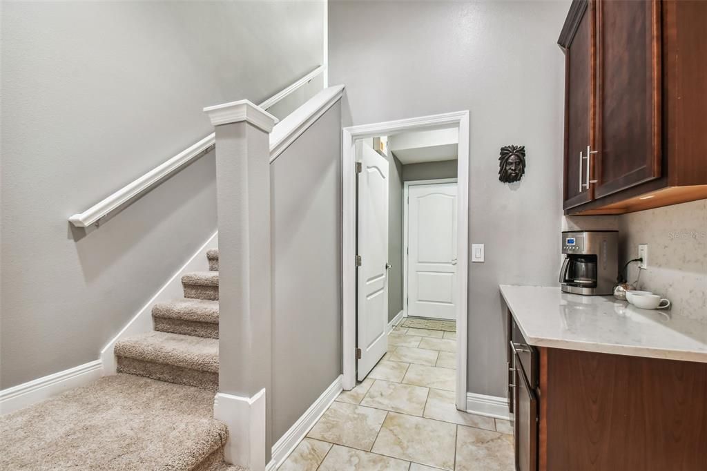 Stairs to Bonus Room located between Kitchen and Dining Rooms. and Beverage Station  Also, door to Laundry and Garage