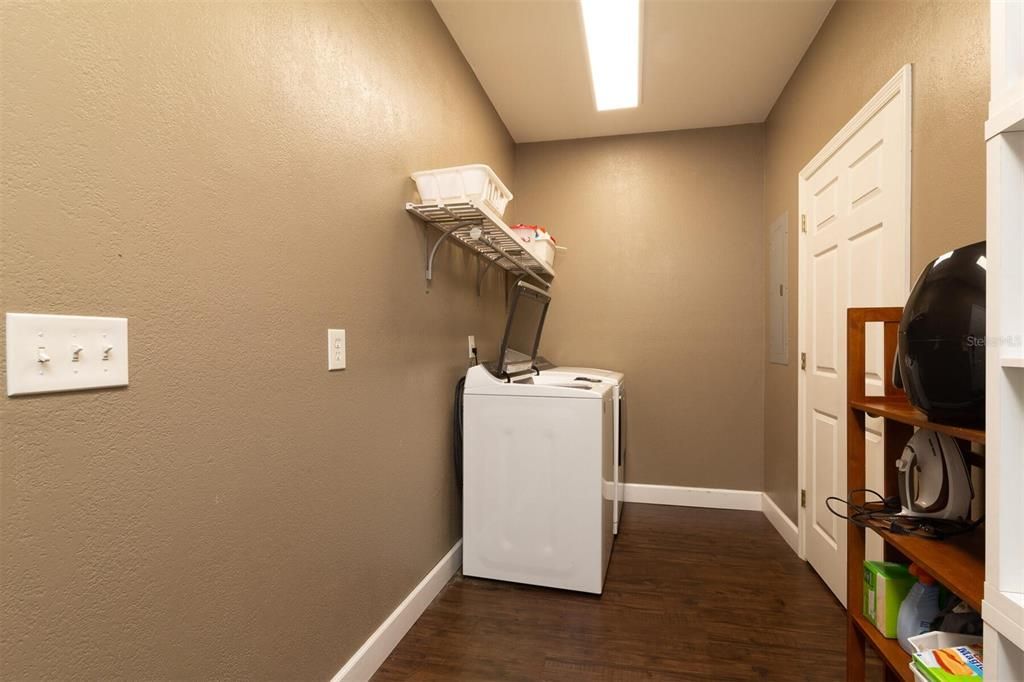 Large laundry room off kitchen with storage