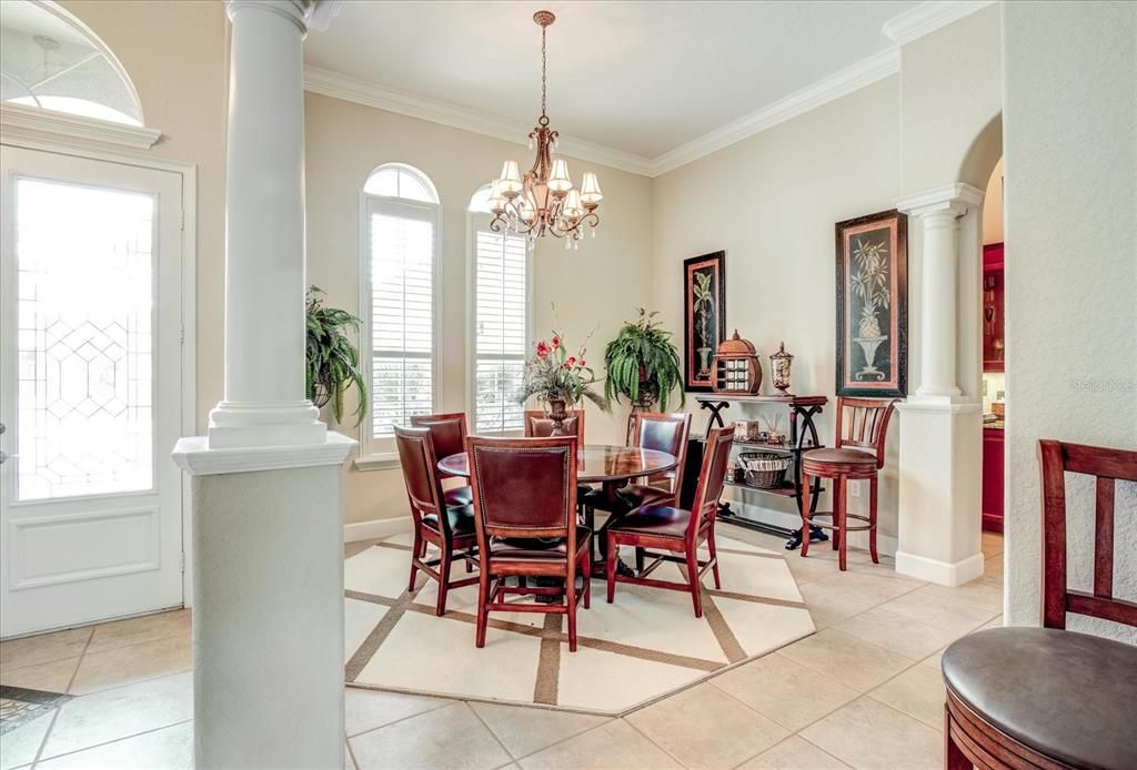 Formal dining room with arches & columns.