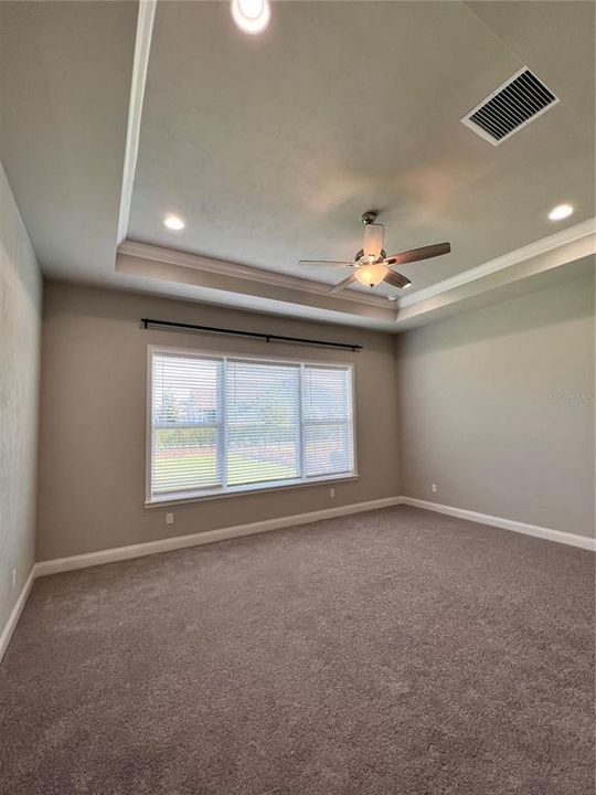 Master Bedroom with ceiling fan and many lights