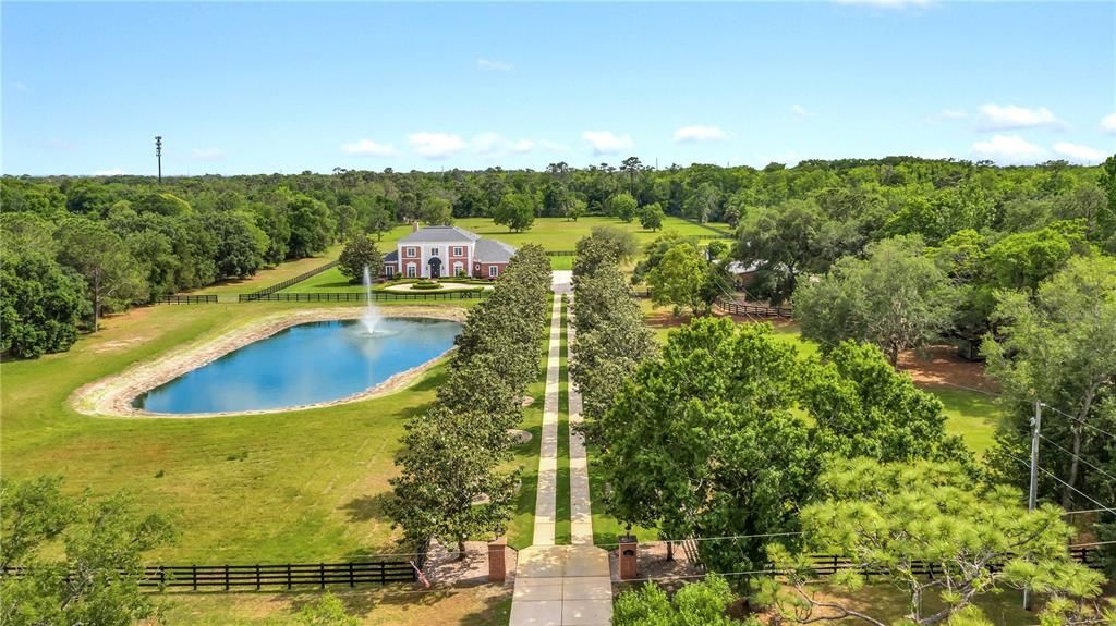 Property with tons of privacy, with a private pond, and stable to the right.