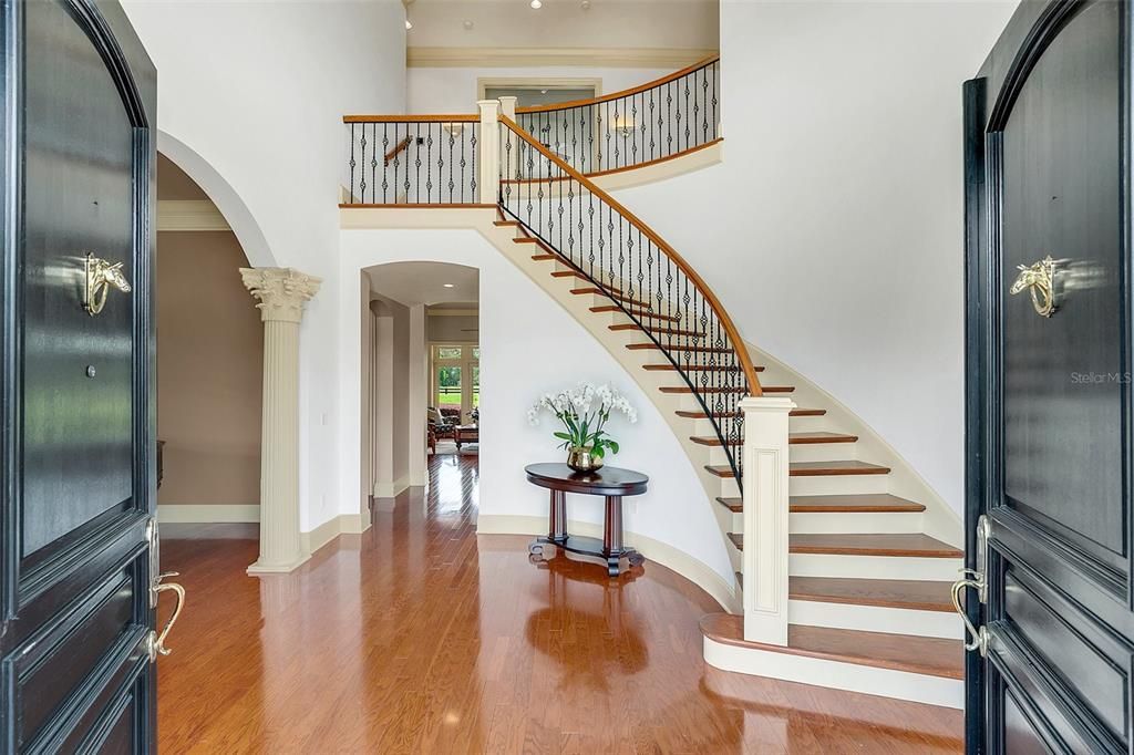 Grand foyer with winding staircase to the 2nd level