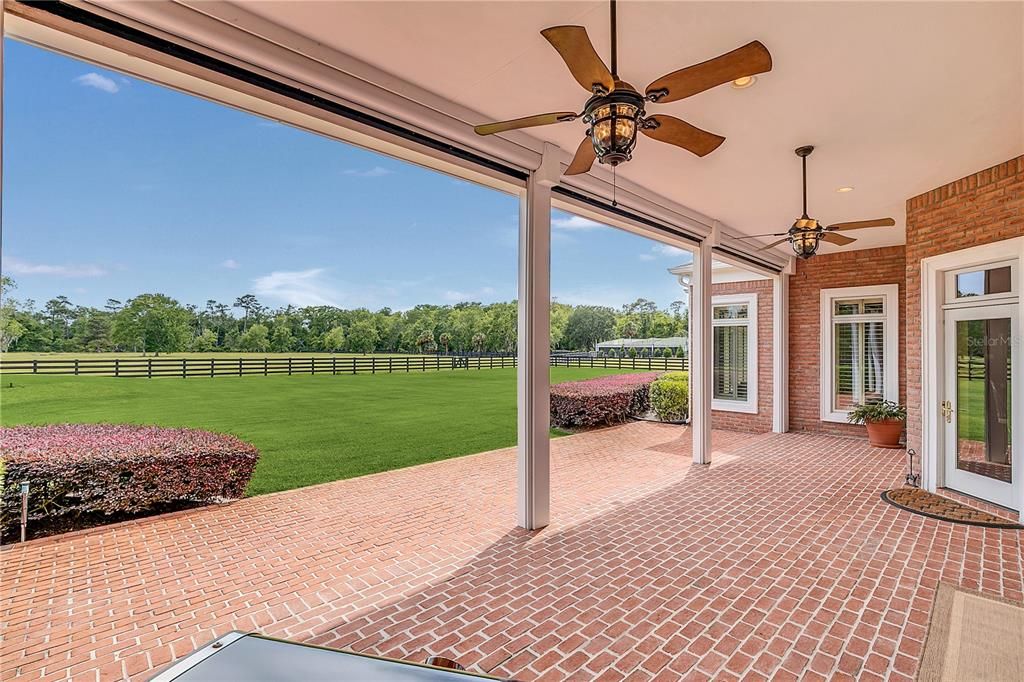 Covered, rear brick patio with ceiling fans & gorgeous views