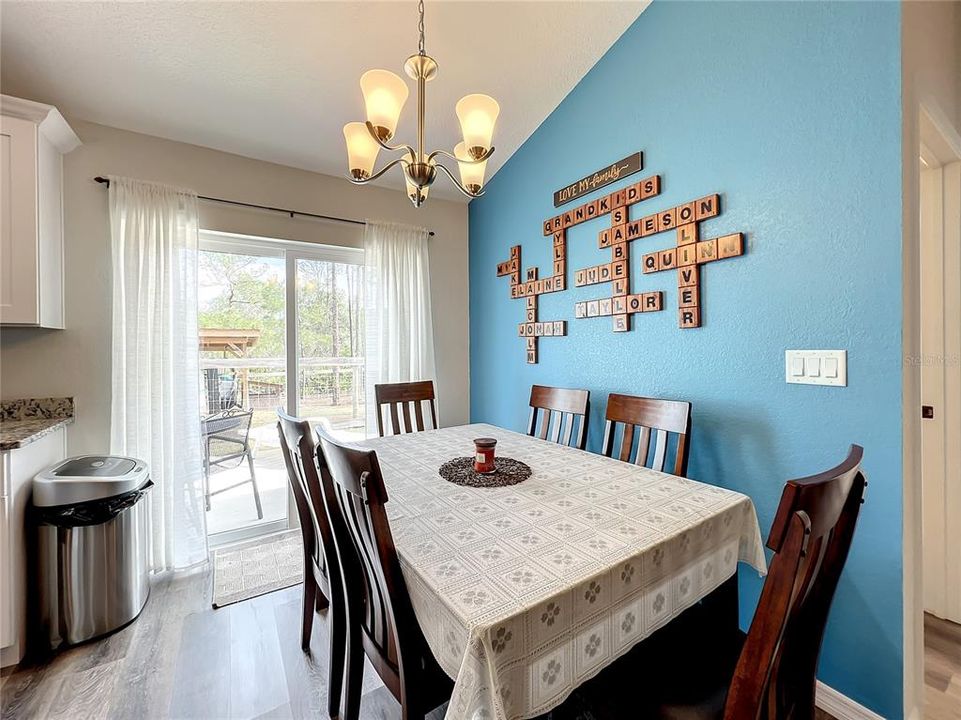 Dining room is right off the kitchen with sliding doors to the backyard oasis