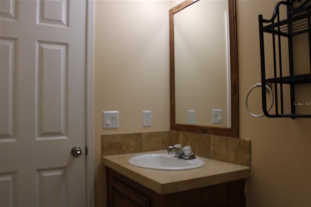 Guest bathroom has a tub/shower combo.