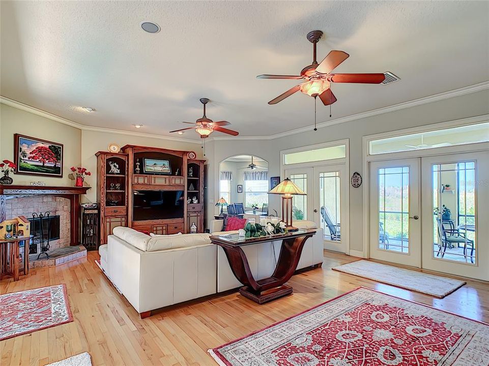 Great room with fireplace and doors to porch and canal