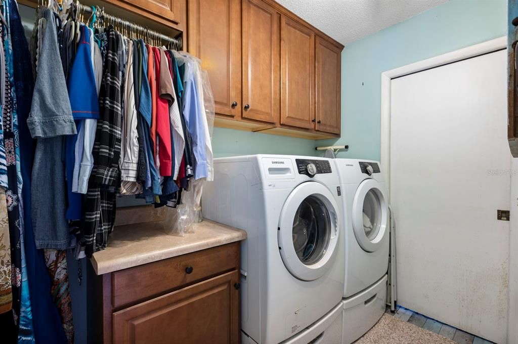 Laundry Room with cabinetry and drying rack annnd storage!