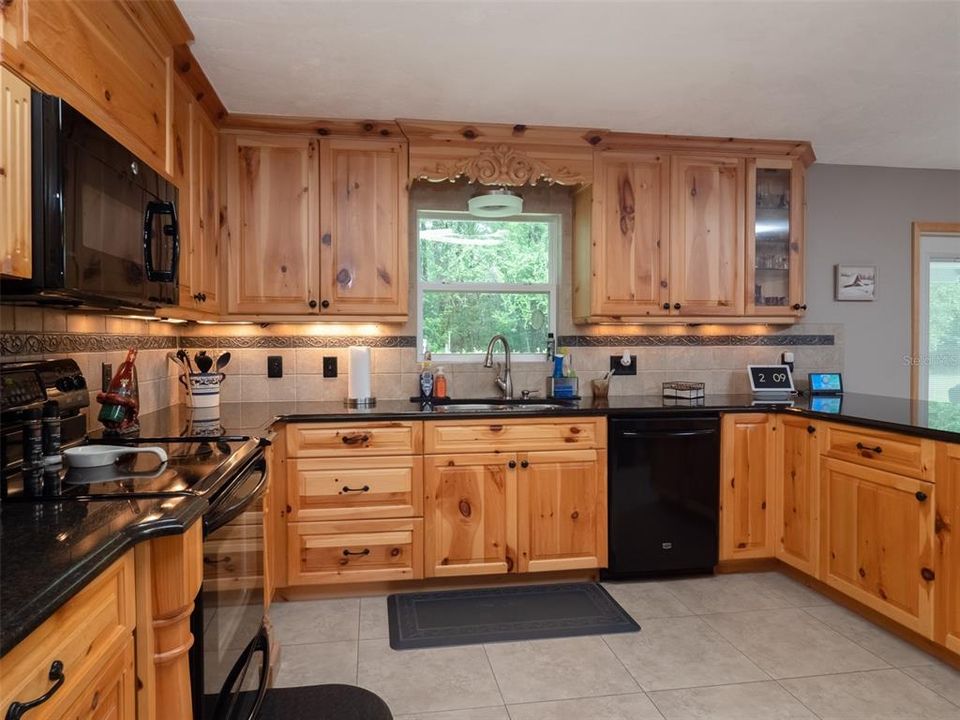 Kitchen, featuring granite counters, solid wood (pine) cabinets, tile floors