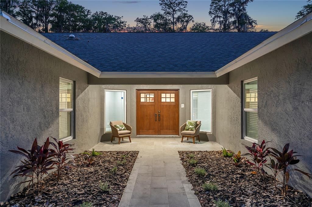 Double entry doors that lead into a large foyer area. It is perfect as a study or to showcase your favorite artwork.