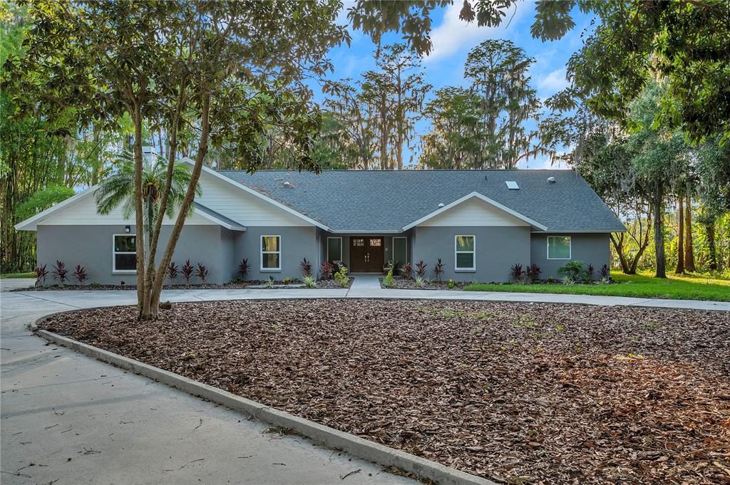 Expansive driveway will lead you from the entrance to the home and guest home.