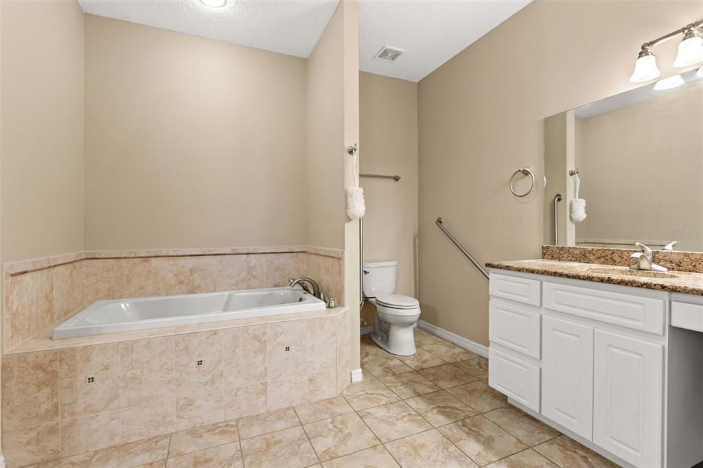 Primary Bathroom with dual vanities, garden tub and walk in shower