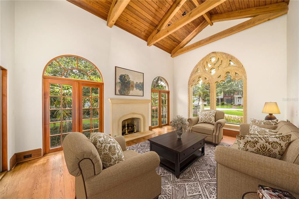 Formal living room with pecky cypress beams and vaulted wood ceiling.
