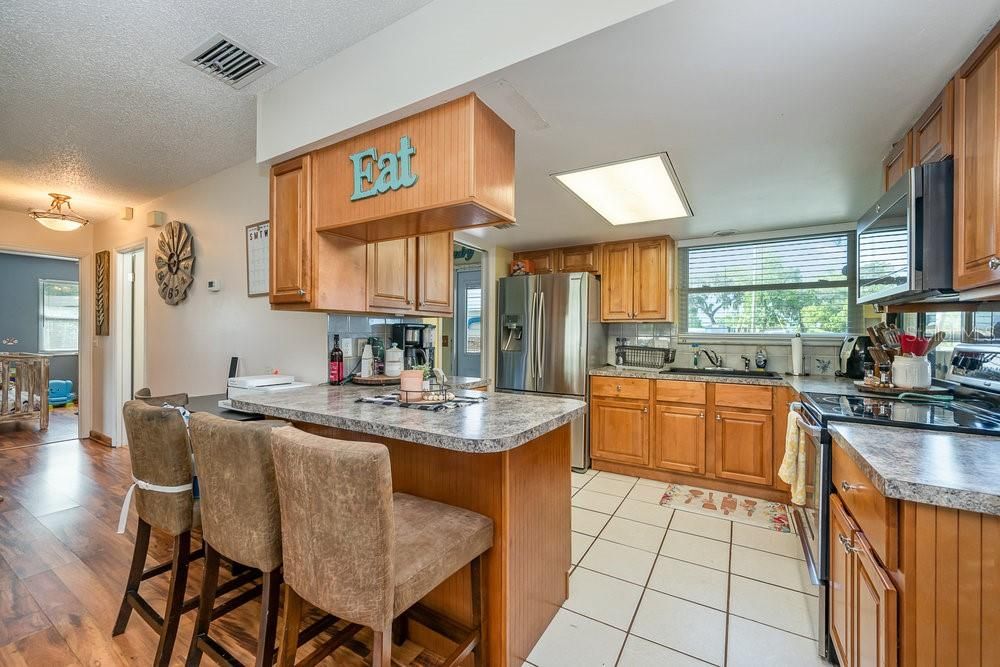 Lots of cabinets, solid surface countertops. tile floors in kitchen! Nice appliances