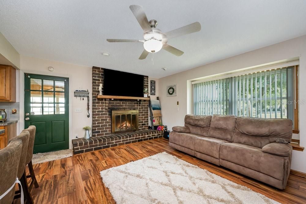 Wood look laminate flooring and cozy fireplace!