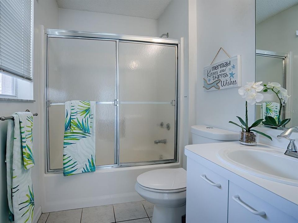 Combination tub and shower with glass doors can be found in the master bath!