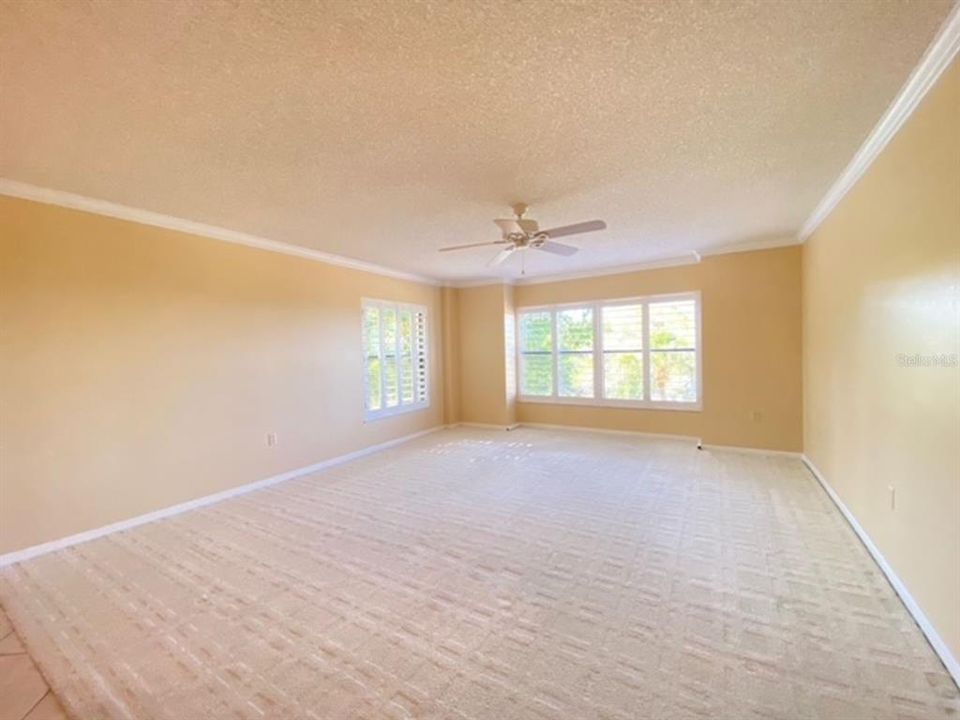 Open living room, view from dining and hall walkway.  Master to the right.