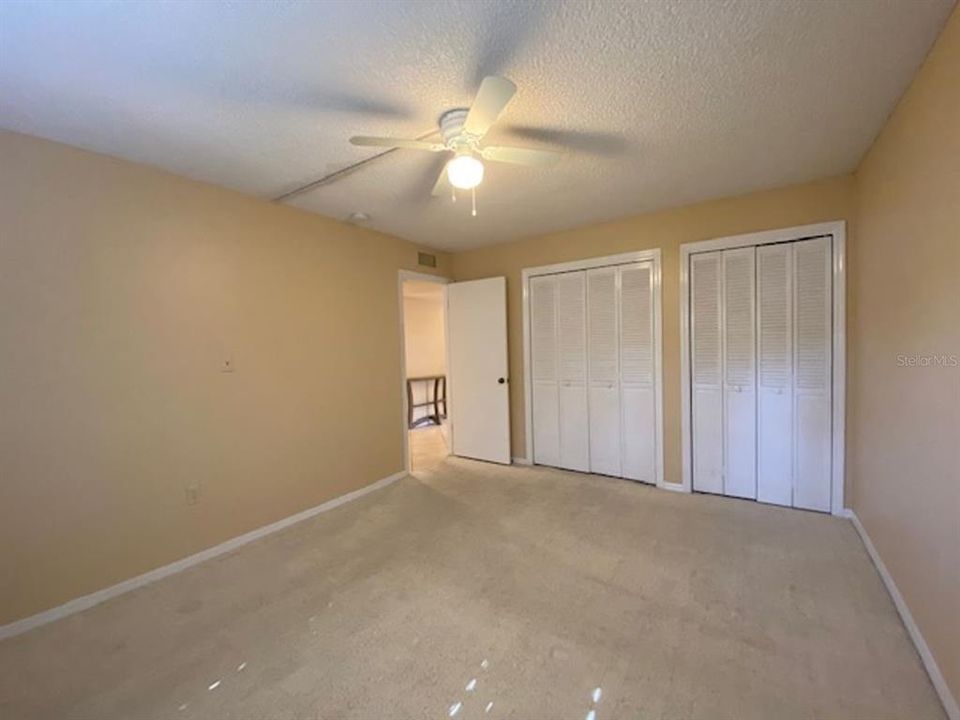 Bedroom 2, with two closets and a large window (on opposite wall)