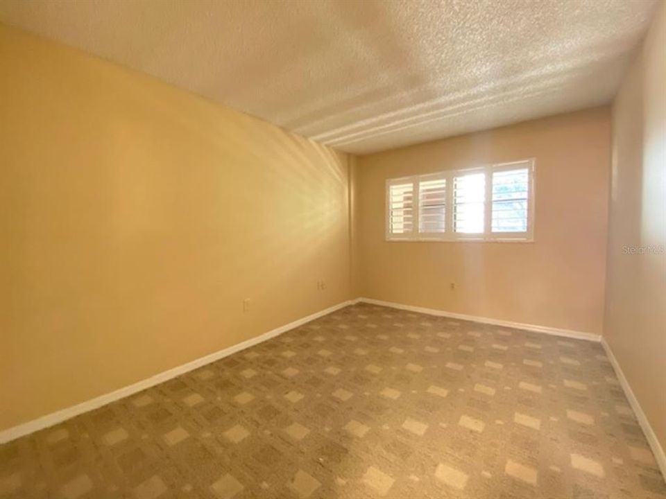 Bedroom 3, which faces out over reserved parking and also the front door walkway.