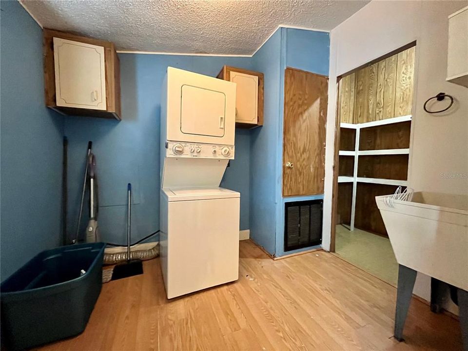 Inside laundry with Washer/ Dryer, laundry tub, & pantry