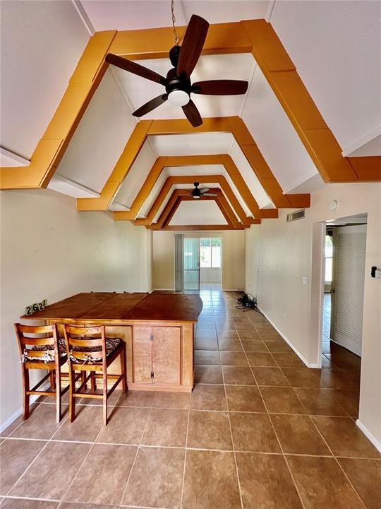 view of entrance and family room with cathedral ceilings.