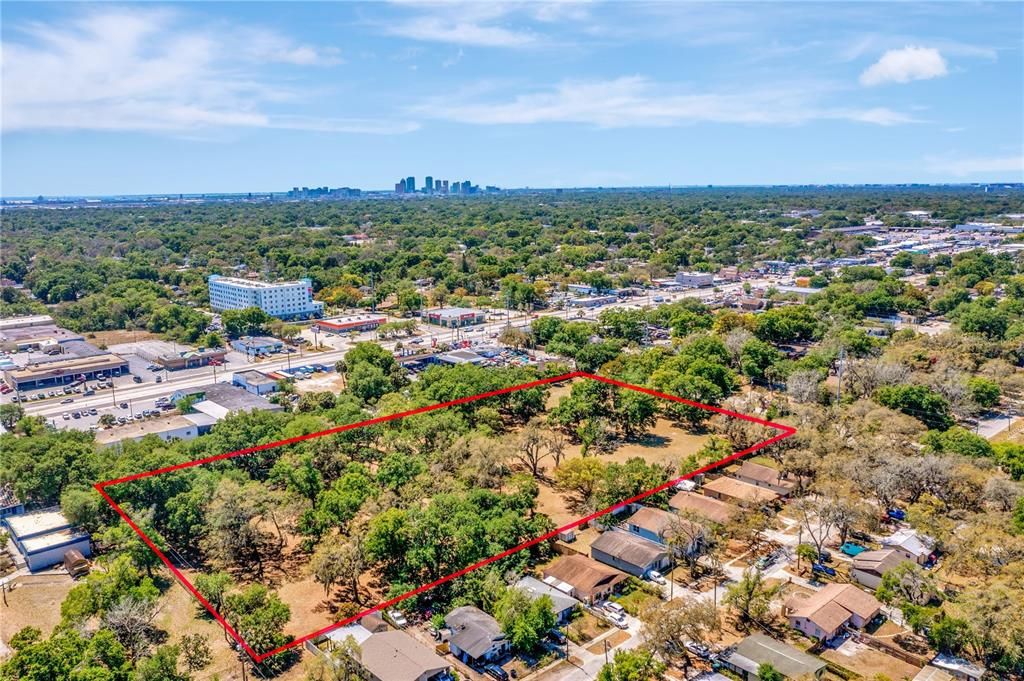 Aerial of property from back left view; Hillsborough Avenue & downtown Tampa view