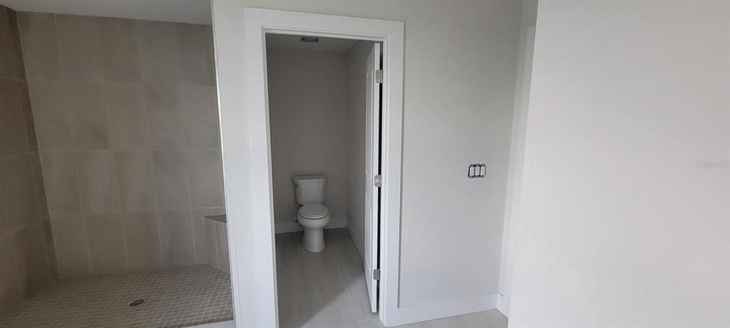 Primary bathroom shower and water closet