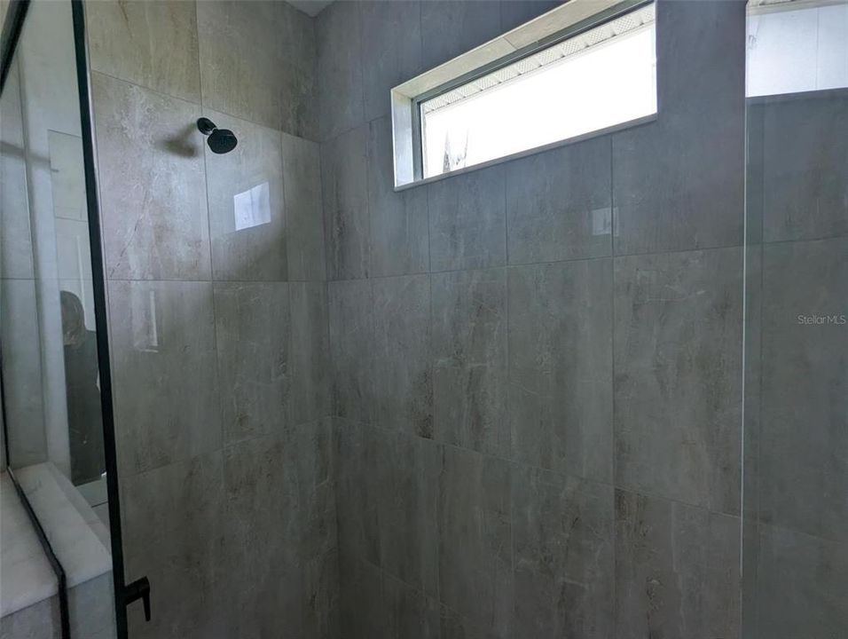 Frameless shower in primary bathroom