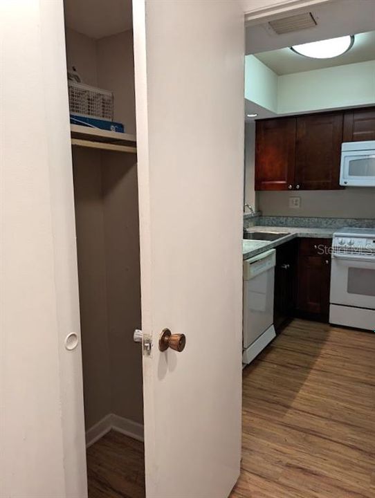 Closet space in laundry area across from washer/dryer