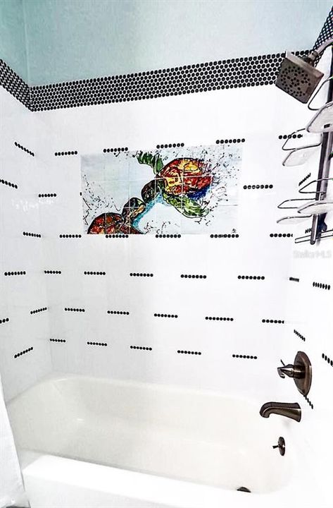 The guest bath has designer tiles with a sea turtle mural for a bit of whimsy in the guest bath