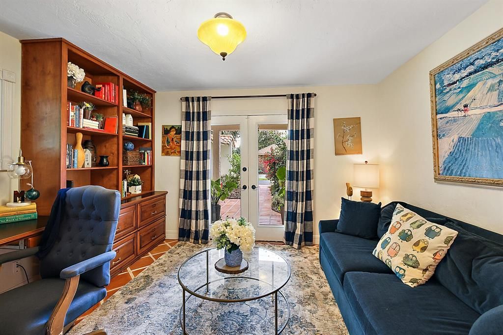 First floor office/den with double glass doors that lead to the outside courtyard