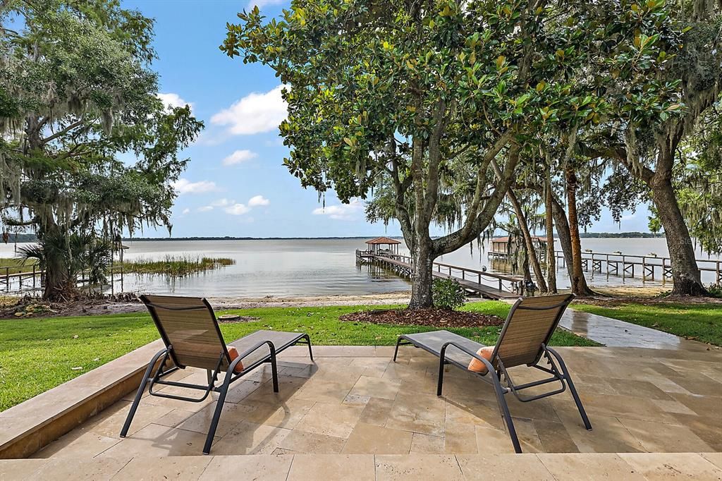 Travertine tile also adorns the sunning patio and pathway to the water and dock.