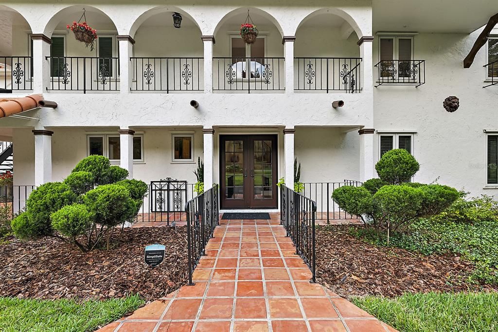 Saltillo Mexican tile, charming upper and lower porches, and a beautiful double glass door entry.