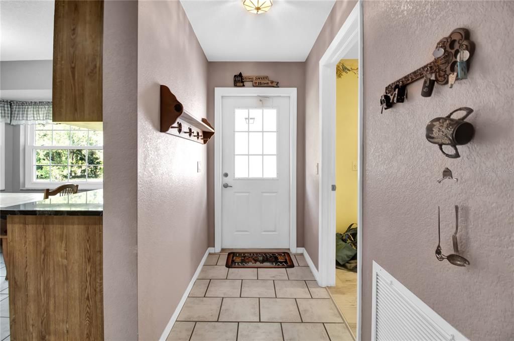 from kitchen to side door leading out to breezeway to garage and right side entry door to laundry room