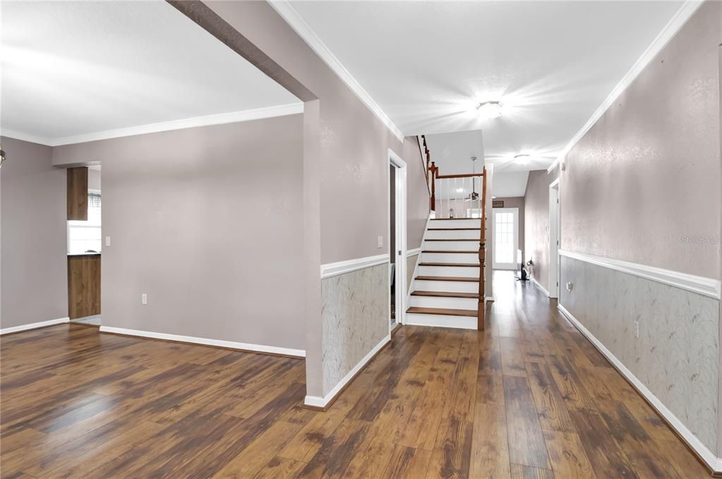 Entry foyer showing dining room on left and stairs to 2 bedrooms up