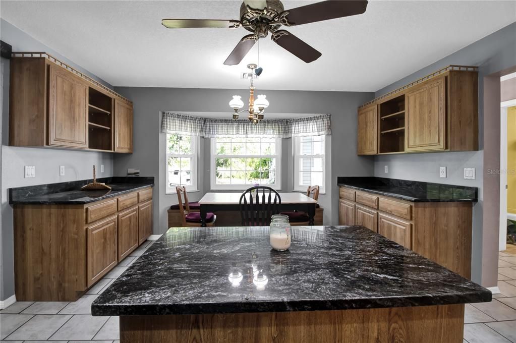 Other view of kitchen showing eat in area and bay window with seat- lots of EXTRA CABINETS!